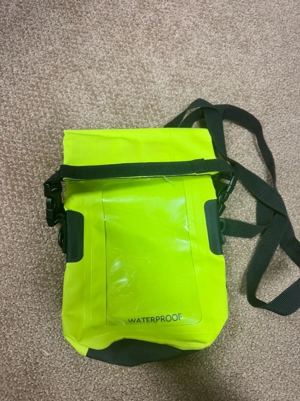 Neon green waterproof dry bag with crossbody shoulder strap