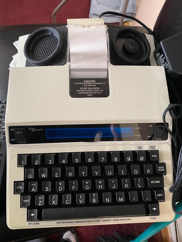 Vintage TTY teletypewriter text telephone with keyboard and paper printer